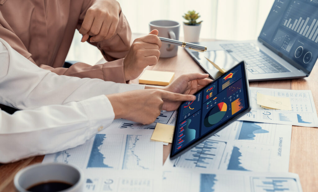 Businesswoman Sitting at Her Desk Working on Laptop Computer in Big City Office. Confident Social Media Strategy Manager Plan Disruptive e-Commerce Campaign